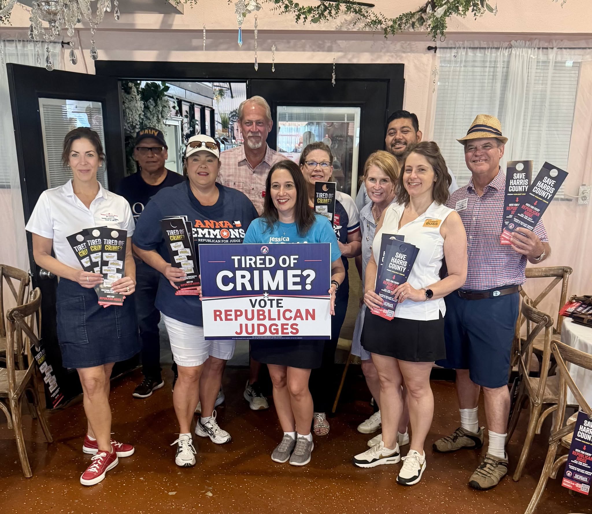 Community members gathered indoors with Republican campaign signs and voter guides